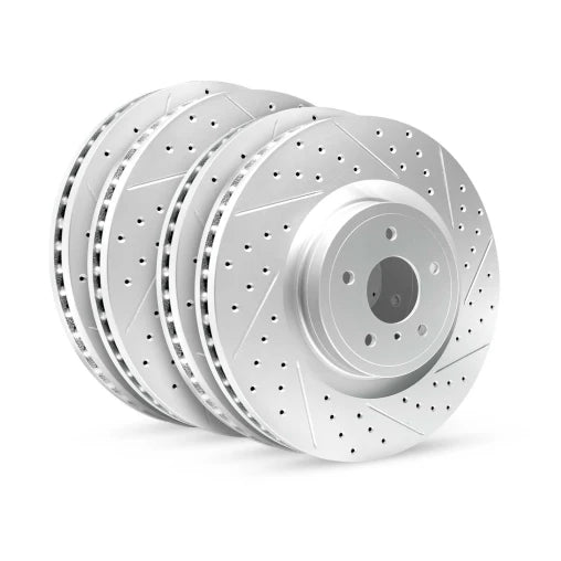 Four metallic brake rotors on a white background