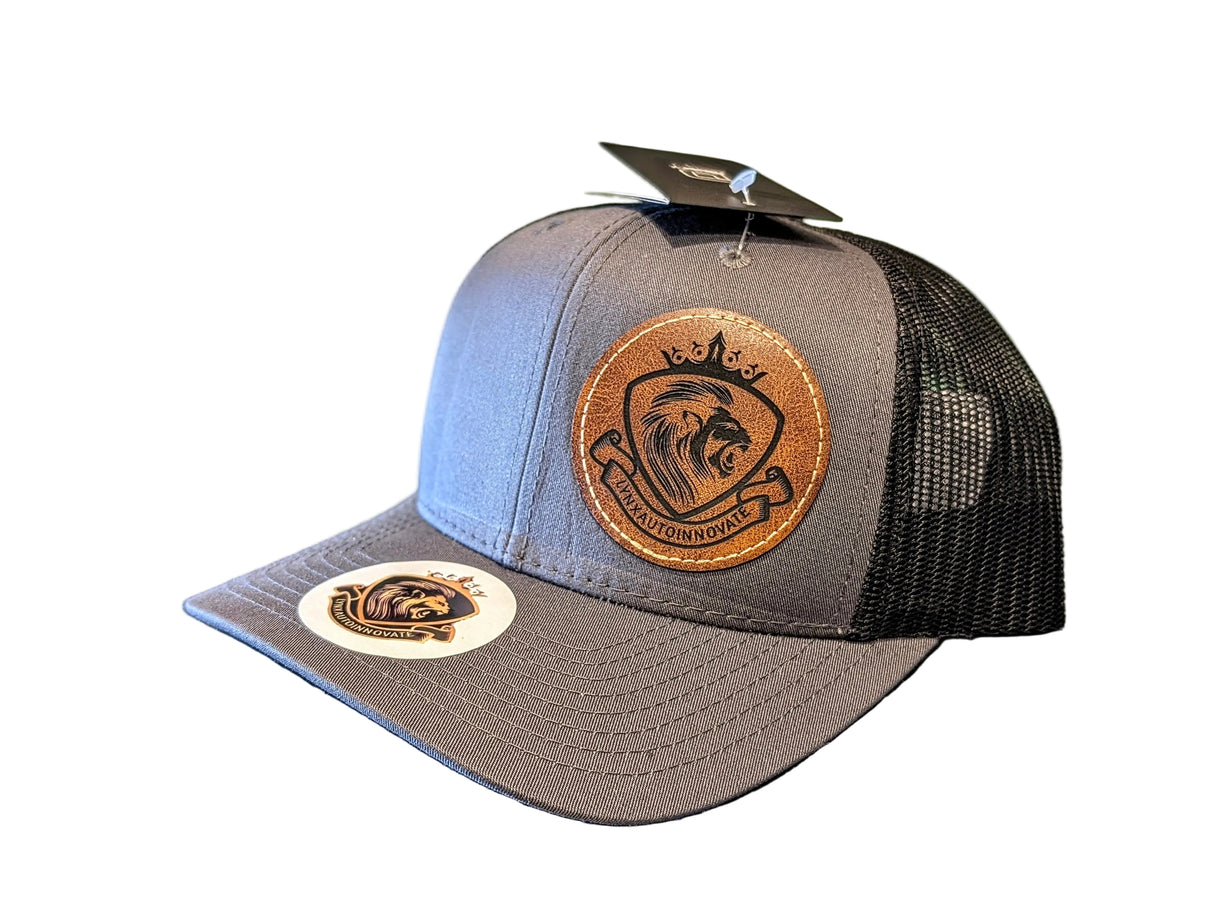 Gray and black trucker hat with leather patch
