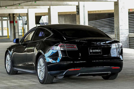 Black Tesla Model S with AlphaRex LUXX taillights in parking garage, LynXautoinnovate USA
