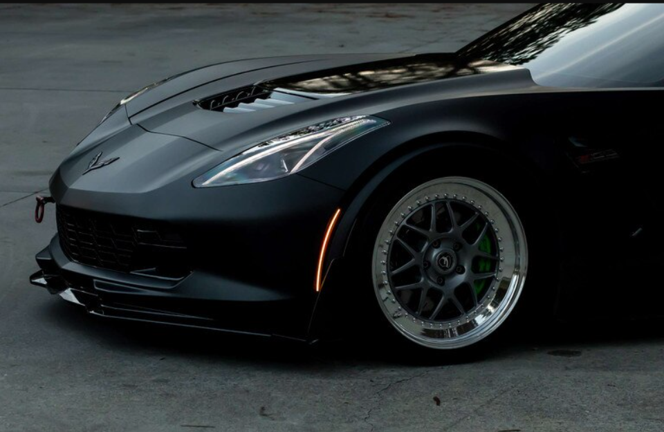 Front view of a black sports car with custom alloy wheels, LynXautoinnovate automotive parts USA