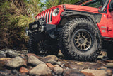 Red Jeep along a river side 