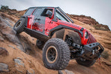 Red Jeep Flexing, demonstrating how the new fender gives room to go anywhere the jeep allows