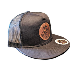 Black mesh cap with leather patch and logo on a textured surface