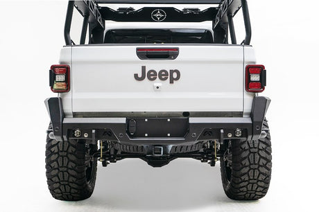 Back view of a white Jeep truck with visible branding on a white background