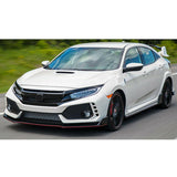 White Honda Civic Type R driving on a road with greenery in the background